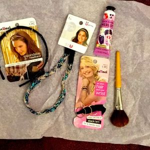 Three hairbands and cream Aveda make up brush